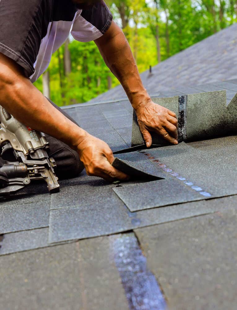 A technician performs commercial flat roof repair with tools for flat roof restoration.