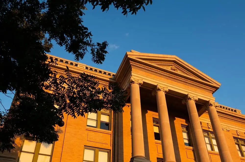 A historic brick building with a flat roof highlights commercial roof repair services.