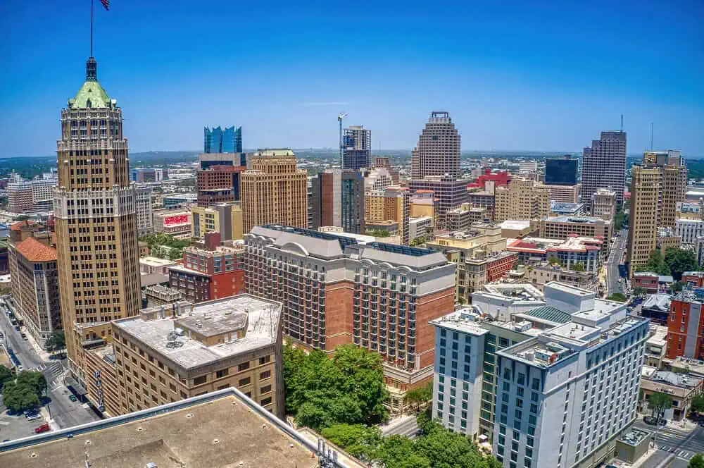 Aerial view of downtown San Antonio with flat roofs, metal roofs, and commercial roofing.