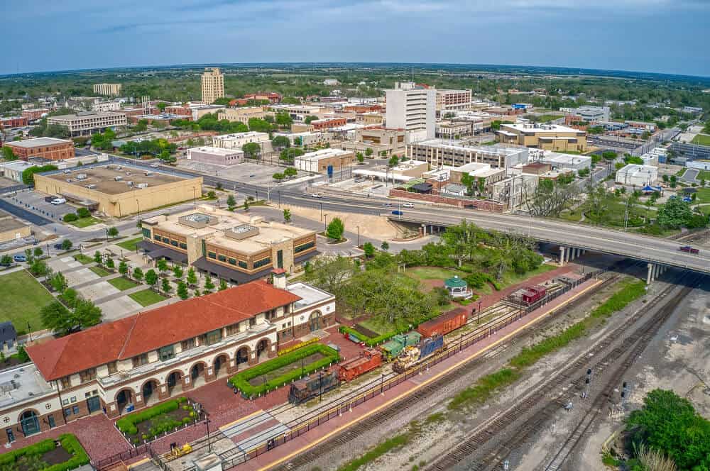 Aerial view of a city with flat roofs, commercial roof repair, and metal roofs visible.